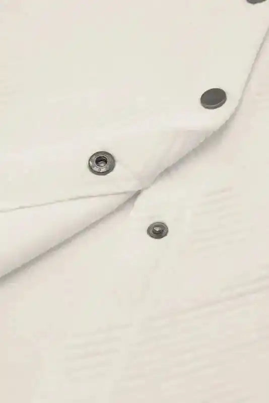 Detailed view of snap button closure on textured plus size jacket, highlighting durable hardware and soft ribbed material.