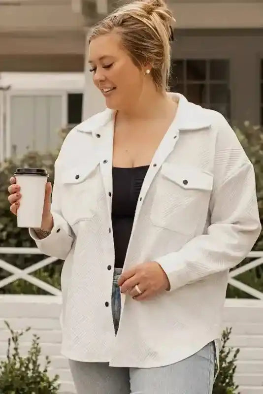 Woman wearing white plus size textured jacket holding a coffee cup, highlighting its casual winter style and comfort.