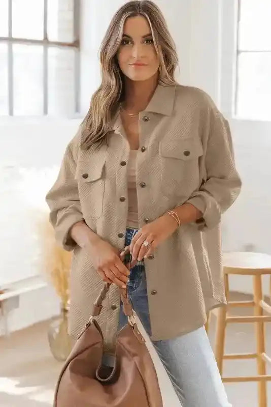 Model showcasing beige plus size textured jacket with oversized fit and front pockets, ideal for casual winter styling.