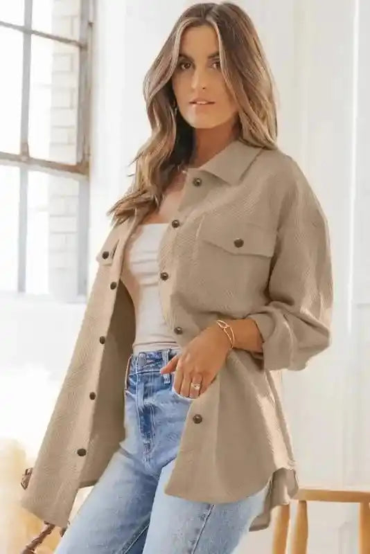 Beige textured plus size jacket styled open over a tank top and jeans, perfect for layering in cold weather.