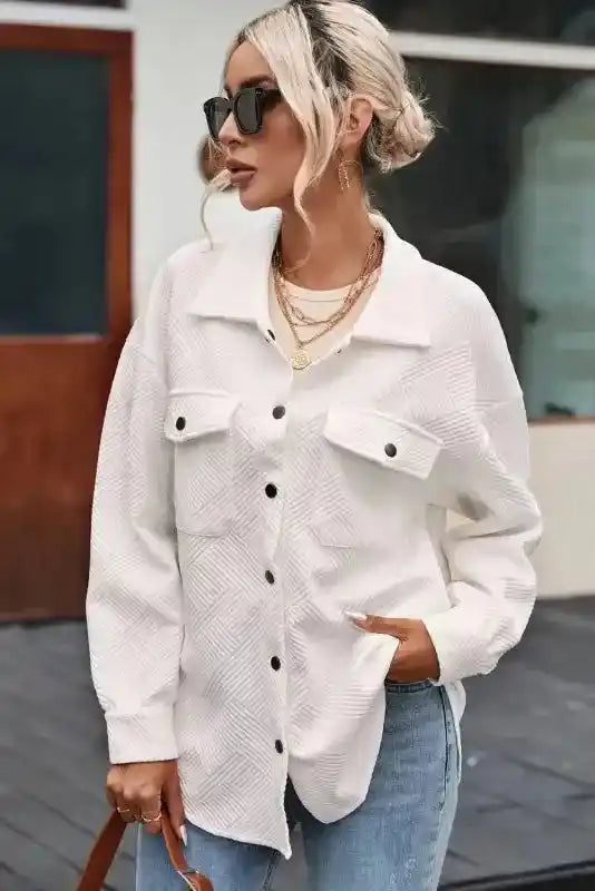 Stylish plus size jacket in white with ribbed texture and black buttons, worn with jeans and layered accessories for winter fashion.