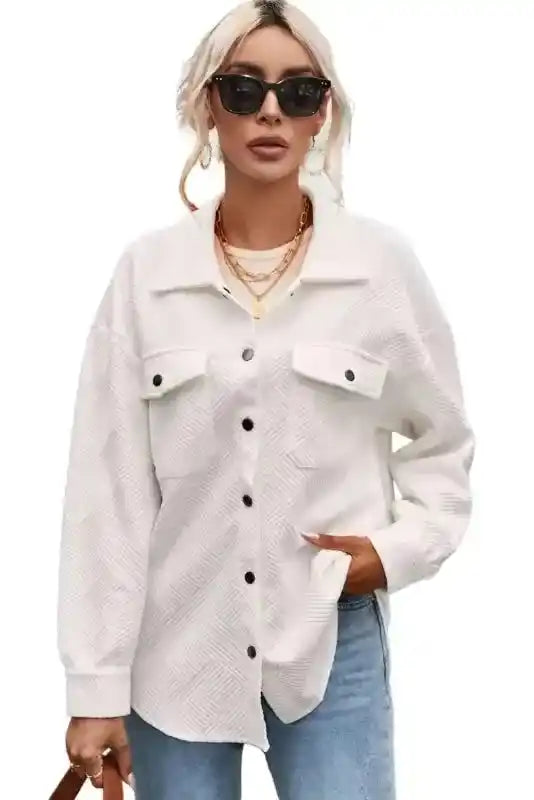 Model wearing white textured plus size jacket styled with jeans, combining comfort and casual winter fashion.