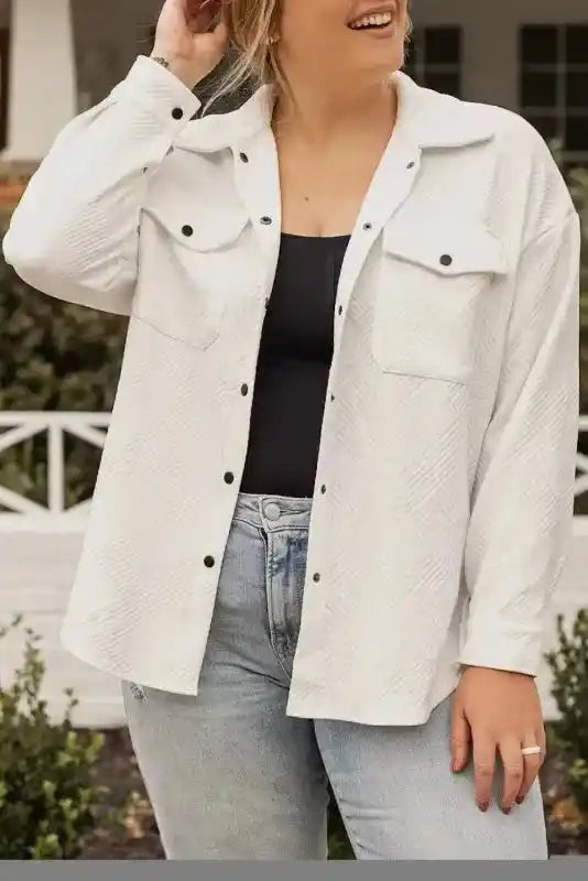 Close-up of plus size textured jacket styled with jeans, emphasizing the ribbed fabric and button details for winter fashion.