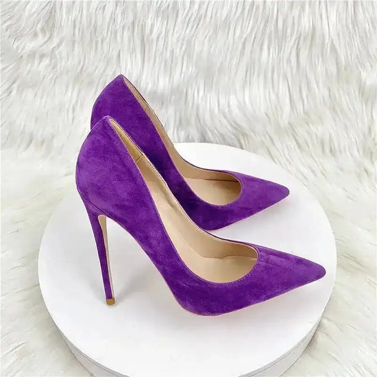 Purple suede stiletto pumps with pointed toe and slim heel, offering a bold and stylish statement. Chic and elegant footwear.
