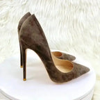 Brown suede stiletto high heels with pointed toe, displayed on a white platform for elegant fashion appeal.