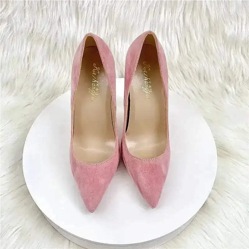 Top view of pink suede high heel pumps with pointed toe, showcasing soft texture and elegant silhouette. Ideal for feminine outfits.