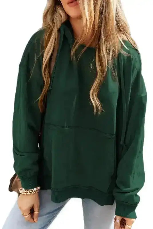 Studio view of green Exposed Seam Hoodie with quilted patchwork and front pocket, styled for casual women's fall fashion.