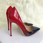 Close-up of Red-Black Gradient High Heels Stilettos on white platform with faux fur backdrop. Sleek and glossy heels for formal events.