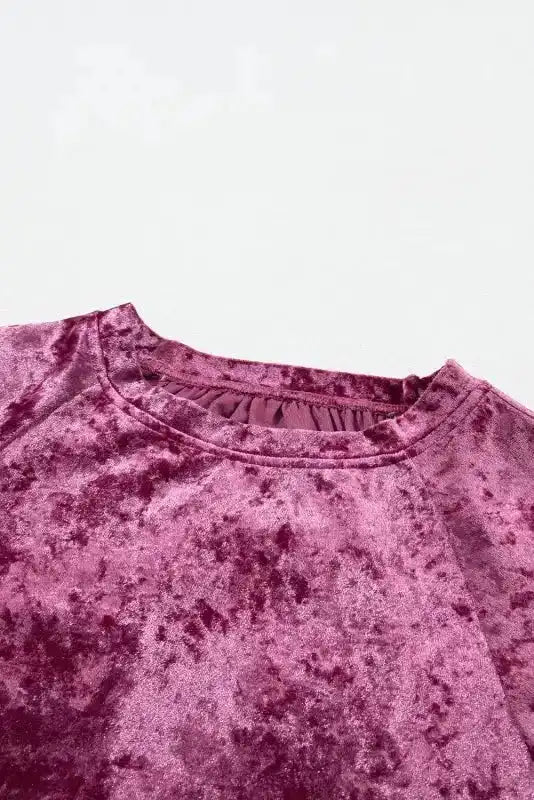 Close-up of crew neck on Velvet Pagoda Sleeve Top - Red Dahlia, showcasing the soft velvet texture and stitching details.