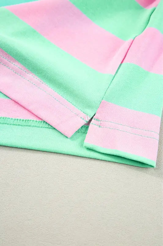 Striped fabric in pastel pink and mint green on a relaxed elegance tee with visible stitching