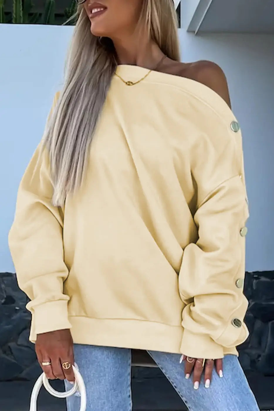 Relaxed fit button-sleeve sweatshirt: off-shoulder pale yellow sweater with sleeve buttons
