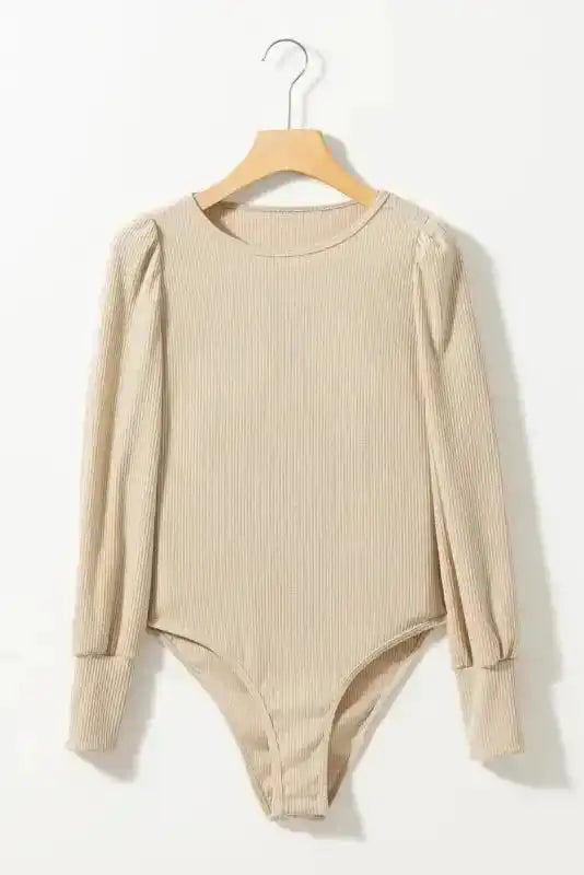 Flat lay of beige Ribbed Balloon Sleeve Bodysuit on hanger, showcasing long balloon sleeves and snap-button bottom closure.