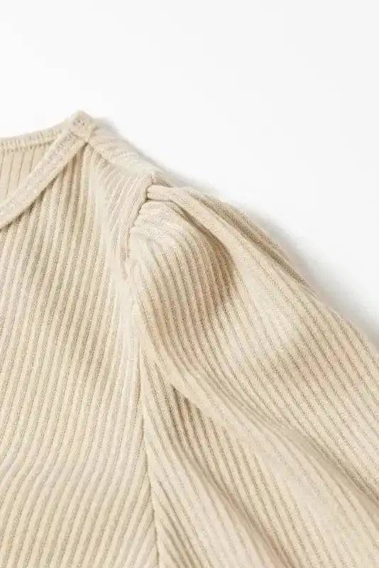 Shoulder detail of beige Ribbed Balloon Sleeve Bodysuit highlighting gathered puff sleeve and ribbed fabric texture.