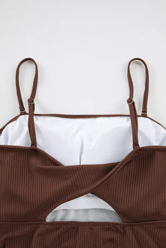 Brown ribbed crop top with thin straps, wrap front; accentuates bust, waist, and hip measurements