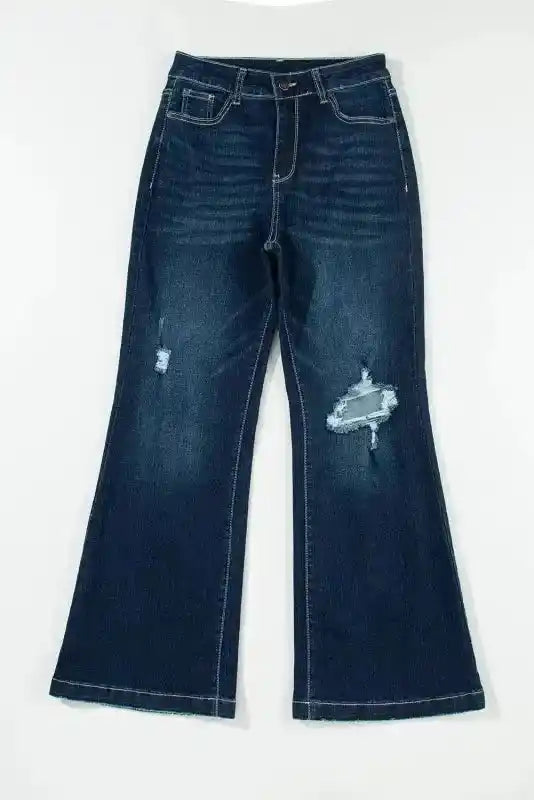 Flat lay of Ripped Bell Bottom Jeans showing front distressing and flared leg, ideal for casual spring fashion.