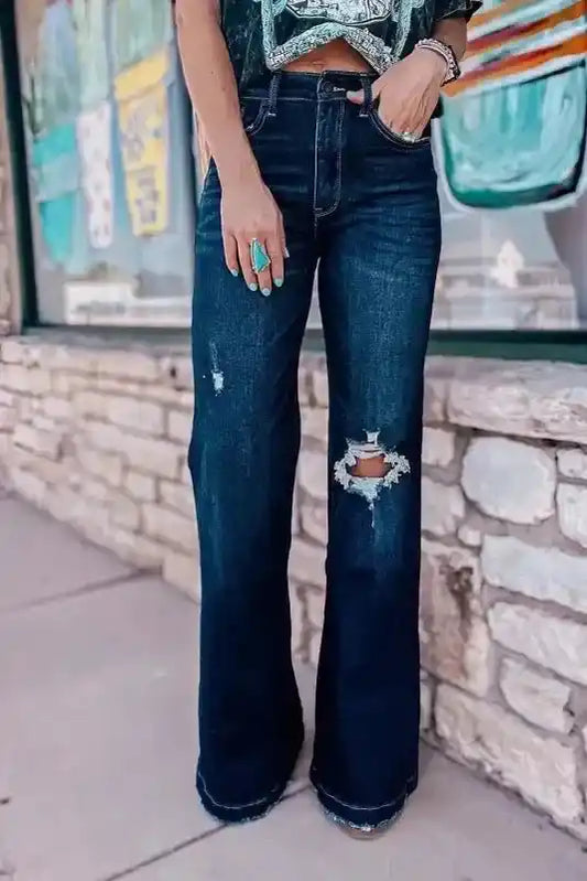 Front view of Ripped Bell Bottom Jeans featuring distressed knee detail and flared leg, perfect for casual spring outfits.