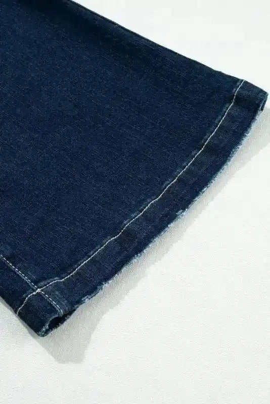 Close-up of frayed hem on Ripped Bell Bottom Jeans, adding a distressed touch to the flared leg style.