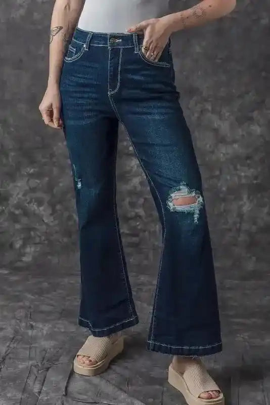 Front angle of Ripped Bell Bottom Jeans with visible distressing and flare, styled for a trendy casual denim look.