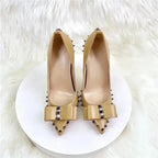 Top view of beige Riviera Bow Court Heels with bow and studded accents, perfect for elegant and modern high heel style.