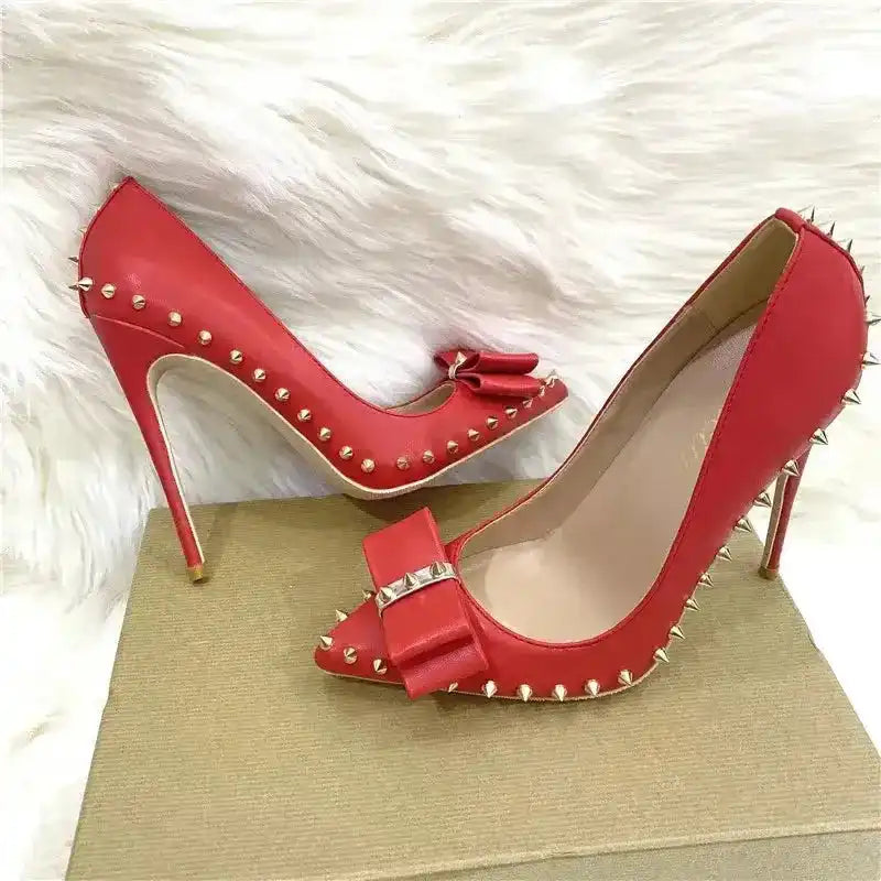 Pair of red Riviera Bow Court Heels with gold studs and bow accents, ideal for standout style in high heel pumps.