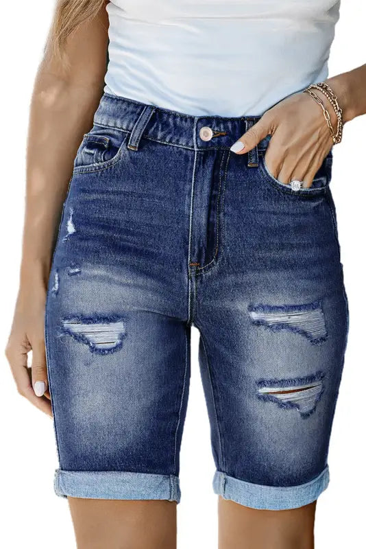 Denim shorts: roll-up distressed bermuda denim shorts with ripped details and cuffed hems