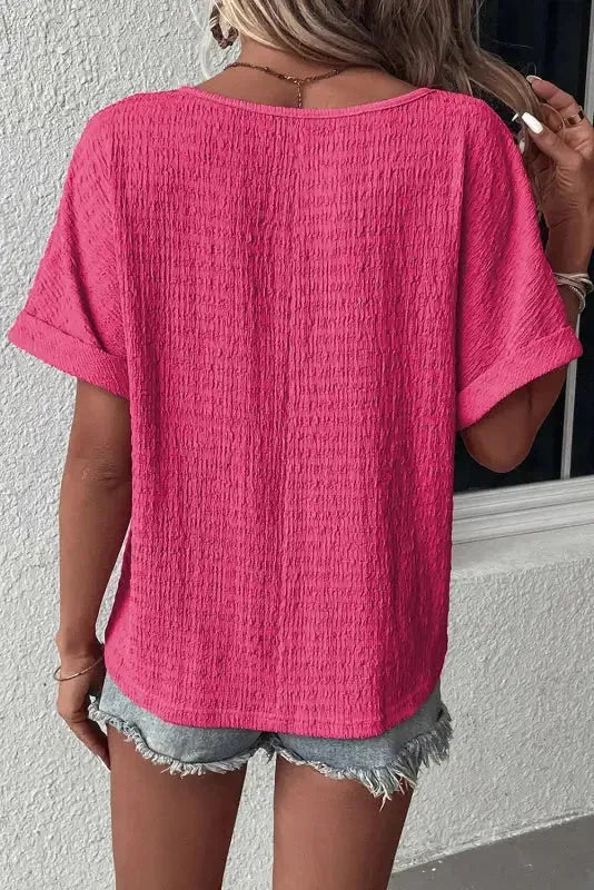 Back view of Textured Rolled Short Sleeve V-Neck Blouse in bright pink showing loose relaxed fit — Fashionfitz