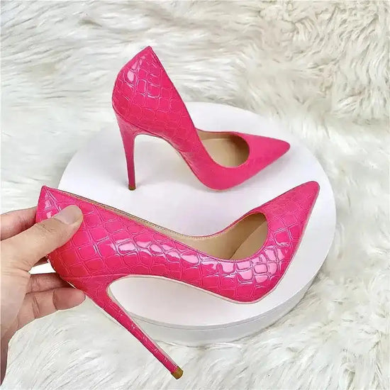 Hand holding Rose Red Stiletto Pumps featuring pointed toe and sleek finish, highlighting premium design for women's fashion shoes.