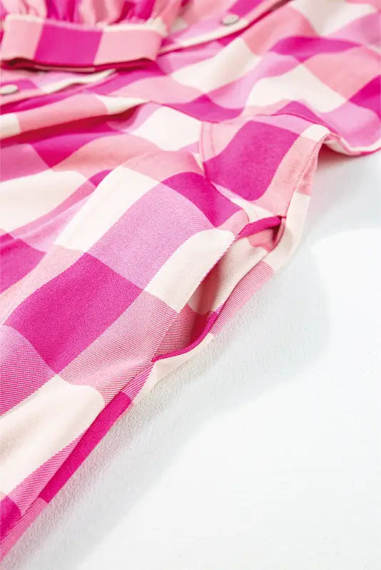 Rose tartan twist mini dress in pink and white checkered fabric with relaxed folds