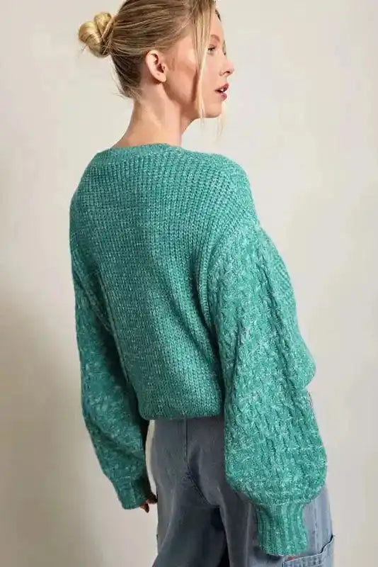 Back view of Sea Green Cable Knit Sleeve Drop Shoulder Sweater showing relaxed fit and intricate sleeve detailing, ideal for daily winter wear.