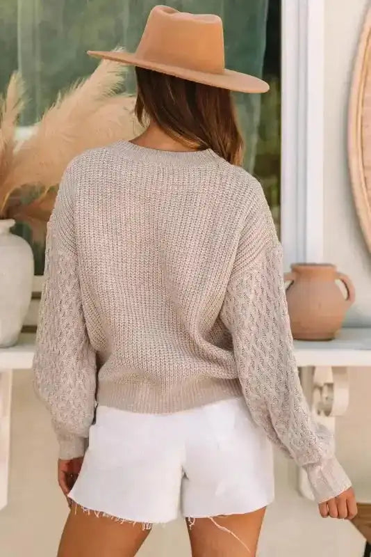 Back view of Beige Cable Knit Sleeve Drop Shoulder Sweater with textured sleeves and ribbed hem, styled for a casual daily outfit.