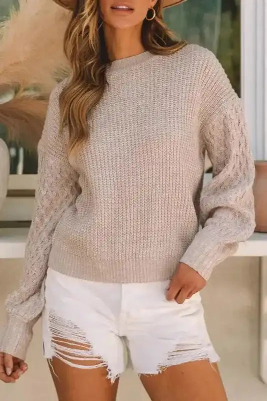 Close-up front view of Beige Cable Knit Sleeve Drop Shoulder Sweater with ribbed hem and intricate sleeve detailing.