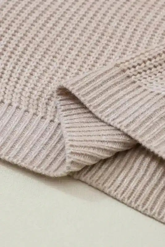 Close-up of hem on Beige Cable Knit Sleeve Drop Shoulder Sweater showing ribbed edge and soft woven texture.