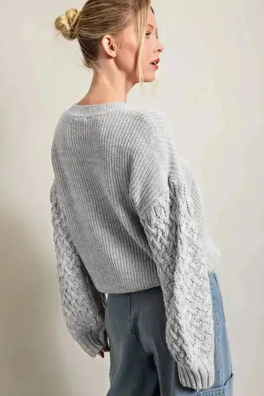 Back view of Sea Green Cable Knit Sleeve Drop Shoulder Sweater showing relaxed silhouette and intricate sleeve detailing, ideal for winter wear.