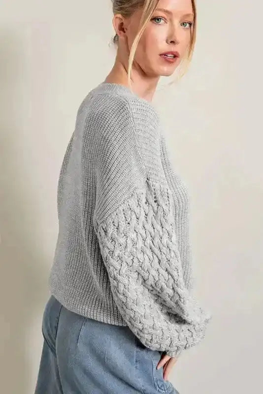Side profile of Sea Green Cable Knit Sleeve Drop Shoulder Sweater highlighting the drop shoulder and cable-knit sleeve design for a chic winter style.