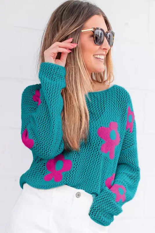 Sea green floral sweater - hollowed knit, worn by smiling woman with sunglasses