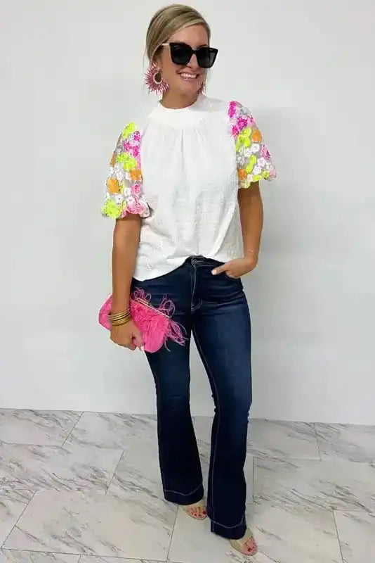 Model wearing Sequin Flower Crinkle Puff Sleeve Top showing smocked collar and dramatic puff sleeve shape — Fashionfitz