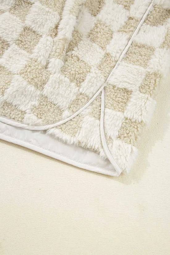 Close-up of a textured Sherpa Fleece Vest with a geometric pattern on a light beige background