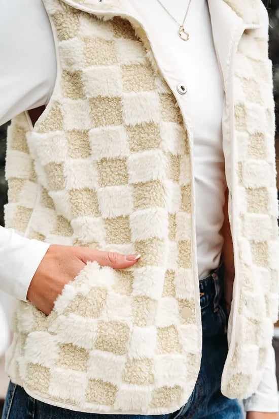 Checkered patterned vest worn over a white shirt with a blurred background