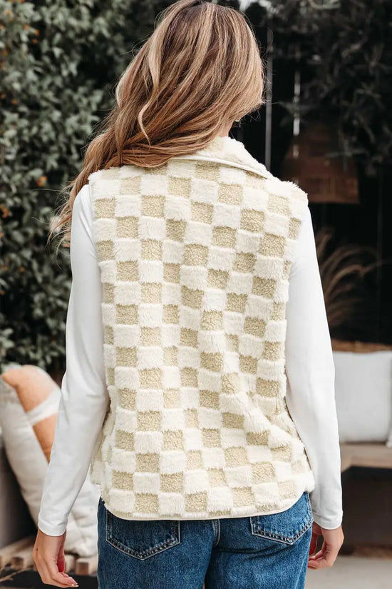 Person wearing a Sherpa Fleece Vest over a white shirt with a blurred background