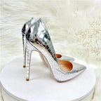 Side-rear angle of Silver Snake‑Effect Stiletto Heels on display stand, highlighting high stiletto heel and textured snake pattern.