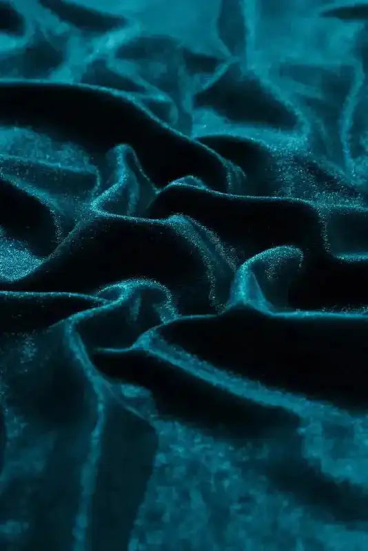 Close-up of Skobeloff velvet fabric texture in deep green, emphasizing its soft and cozy material.