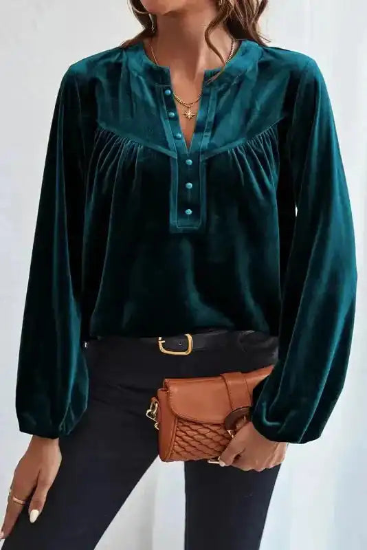 Front view of Skobeloff beaded velvet blouse with long sleeves and V-neck, styled for a chic winter outfit.