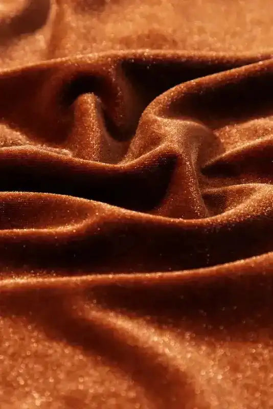 Macro shot of Skobeloff velvet fabric showing plush texture and rich shimmer, ideal for luxurious winter blouses.