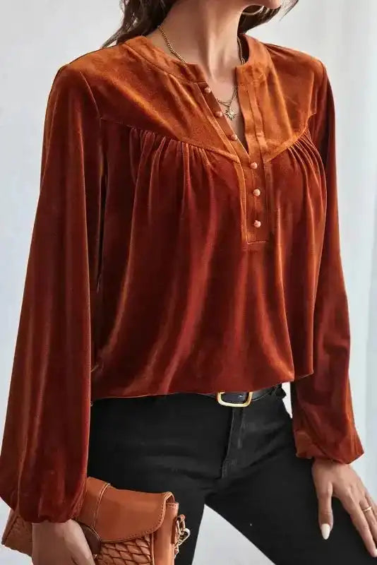 Side view of model in Skobeloff beaded velvet blouse, showcasing its soft drape and gathered yoke for a chic winter look.