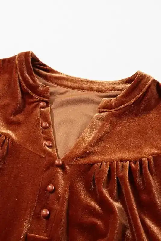 Close-up of V-neckline and beaded button placket on Skobeloff velvet blouse, showcasing sophisticated design elements.