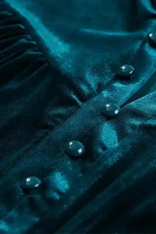 Detail of beaded buttons on Skobeloff velvet blouse, showcasing elegant craftsmanship and rich texture.