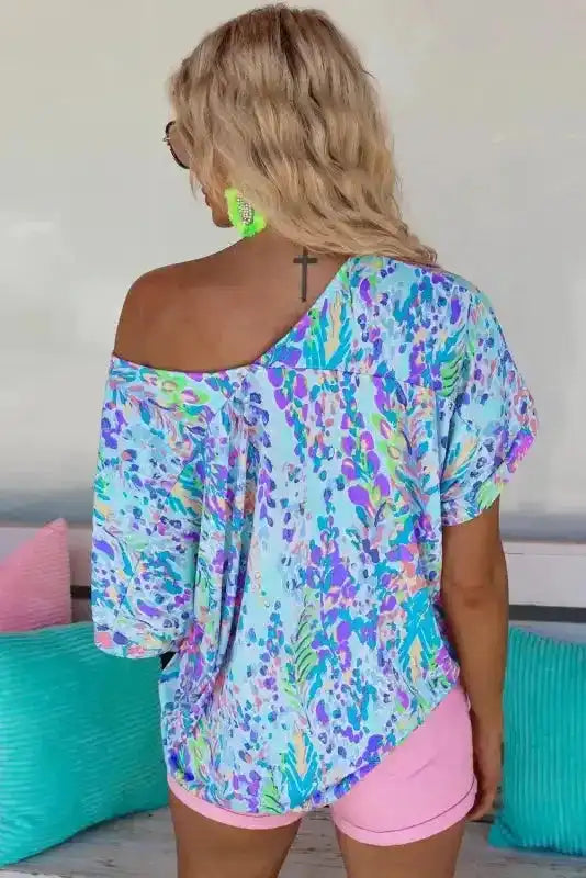 Back view of Painted Floral Loose Fit V-Neck T-Shirt showing loose fit silhouette and longer hem — Fashionfitz