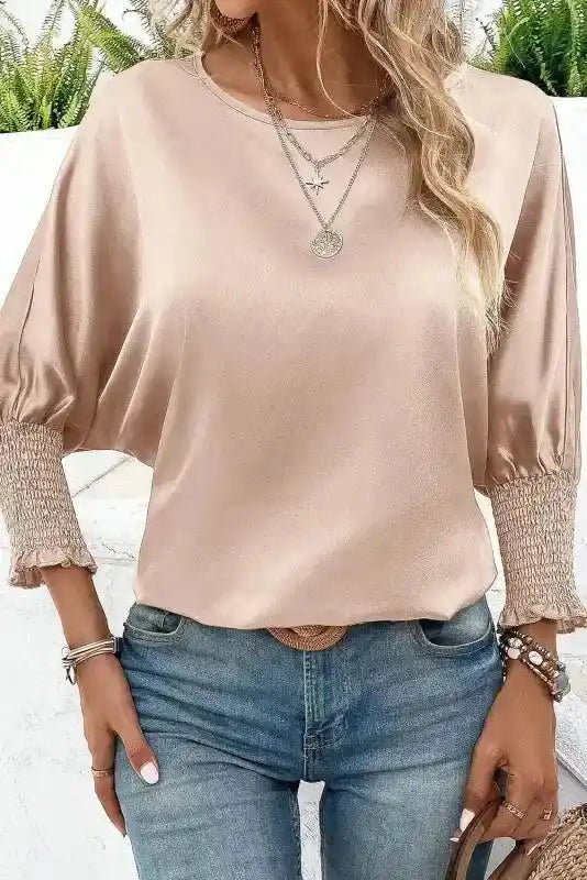 Shirred Elegance Dolman Sleeve Satin Blouse in smoke gray, styled with accessories and tucked into jeans for a polished look.