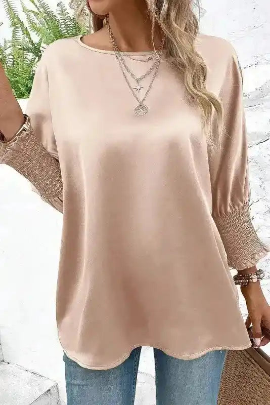 Elegant Smoke Gray Satin Blouse with dolman sleeves and shirred cuffs, paired with jeans for a chic fall fashion outfit.