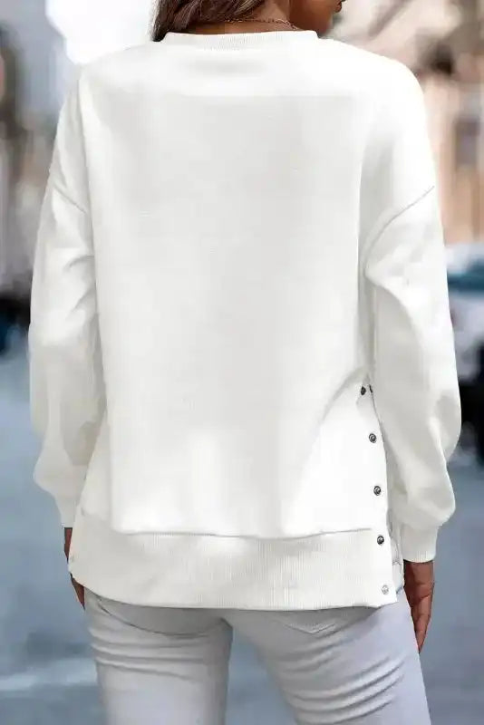 Back view of White Snap Button Pullover showing side button accents and relaxed silhouette for casual winter outfits.
